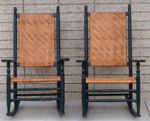 photograph of two cane-back dark blue rocking chairs